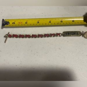 Red brushed gold EMPOWER bracelet.